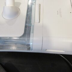 A Philips DreamStation CPAP machine with its water chamber