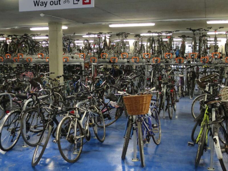 Rows of bicycles in a two-tier cycle park by Cambridge railway station