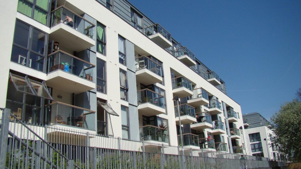 A modern block of flats with balconies beside the Regent's Canal in London