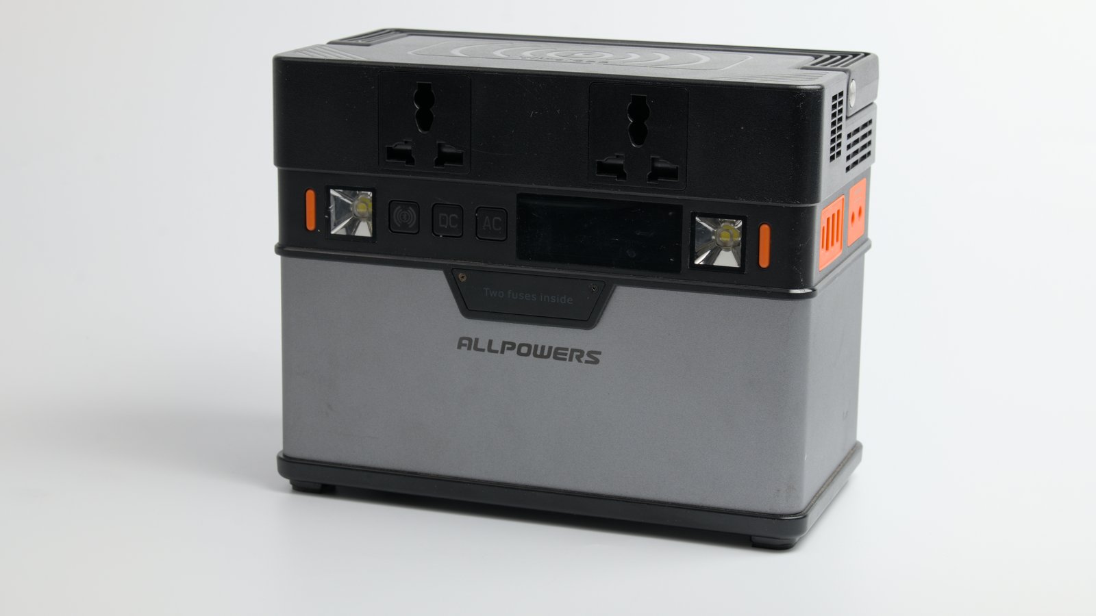 A compact portable power station with sockets and a display on its front panel